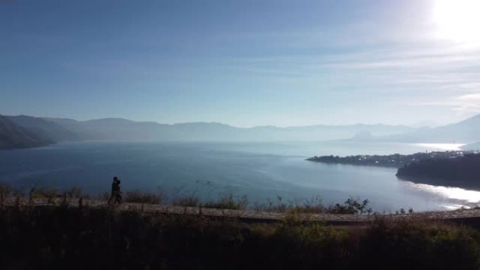 日出时在湖岸散步的夫妇 -- 危地马拉索洛拉圣胡安拉古纳阿蒂特兰湖的夫妇