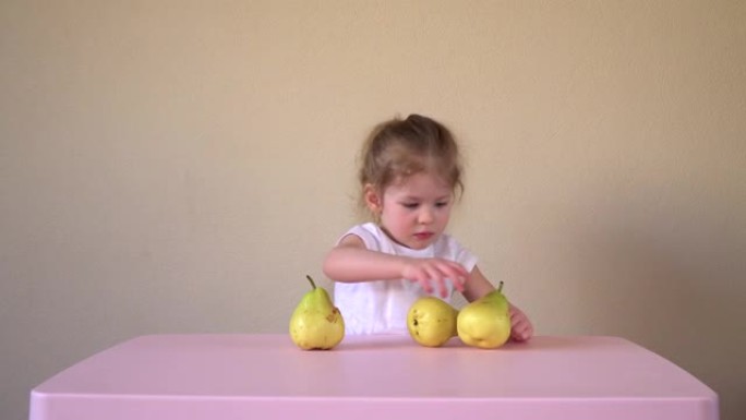 孩子在吃梨。女孩和水果。树的果实。浆果。健康食品。