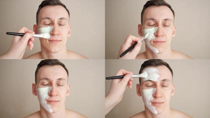 美容师将口罩涂在脸上的男人身上