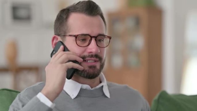 Middle Aged Man Talking on Phone at Home
