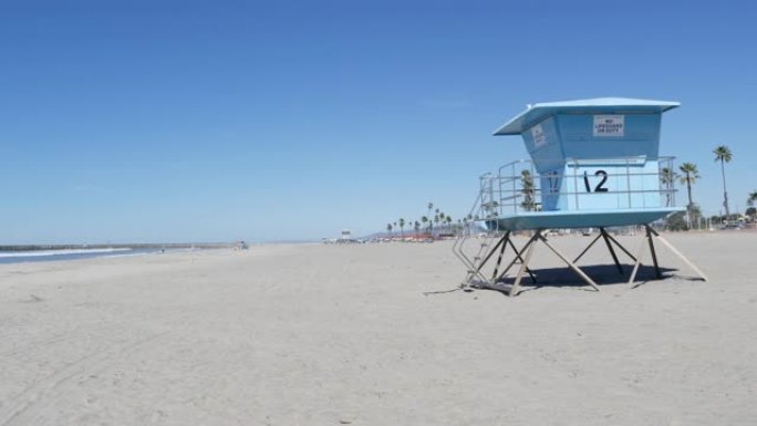 美国加利福尼亚州海洋海岸白色沙滩上的棕榈树。救生员塔，守望台小屋。