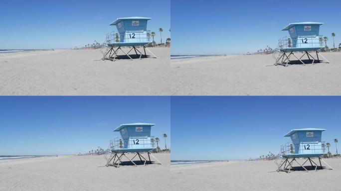 美国加利福尼亚州海洋海岸白色沙滩上的棕榈树。救生员塔，守望台小屋。