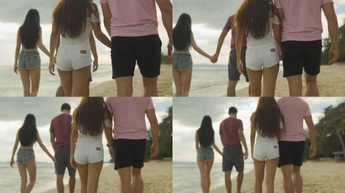 快乐的年轻夫妇在田园诗般的海滩上漫步在海水中享受假期。