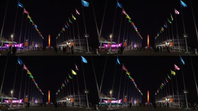 夜间青岛市著名奥林匹克湾步行码头码头纪念碑全景4k中国