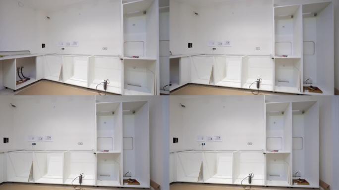 新公寓内部，现代厨房白色家具组装