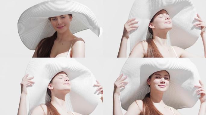 戴帽子的女人在肩膀上涂抹防晒霜，享受阳光