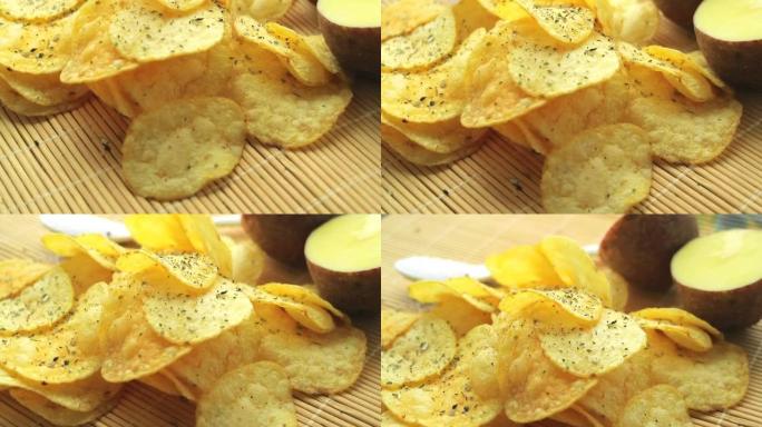 自制薯片。快餐。受欢迎的垃圾食品。马铃薯块茎和薯片在竹餐巾上平稳旋转。糖尿病饮食。