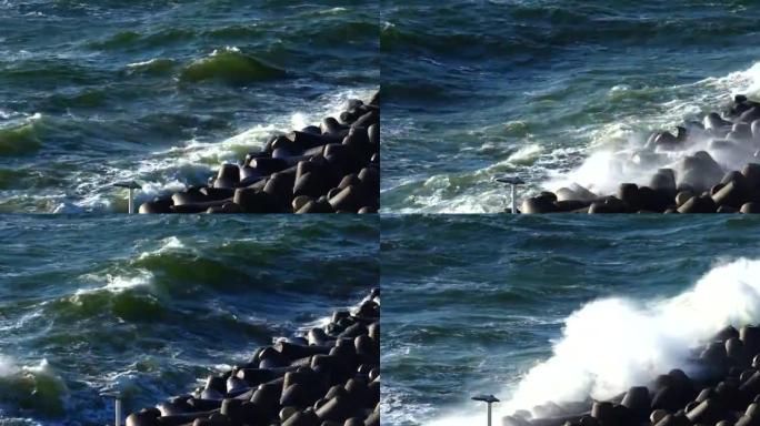 暴风雨的海浪在混凝土防波堤上破裂