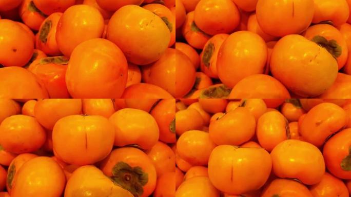 在收获季节放置在市场或集市上出售的新鲜采摘的红色蜂蜜多汁日本水果或amlok的4k特写视图。食物背景