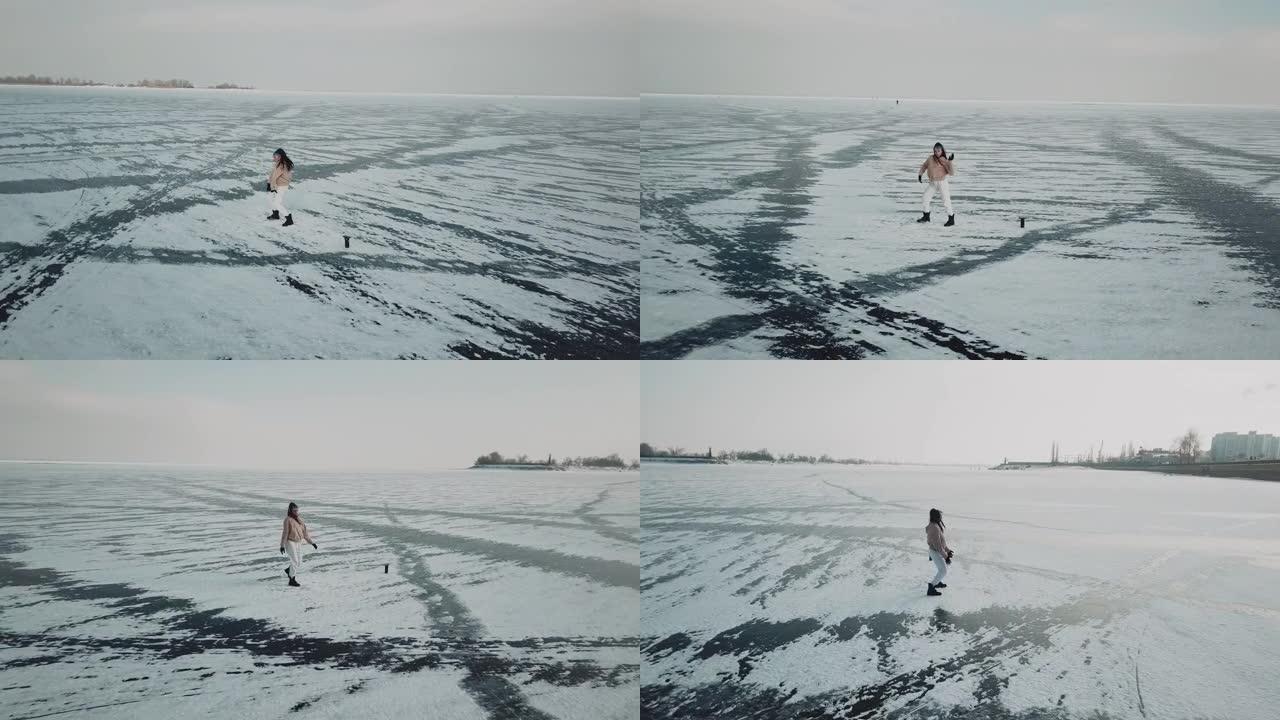 时尚的年轻女子，专业的舞者，在寒冷的冬天在北极冰冻的湖上跳舞充满活力的爵士放克或嘻哈。女性潮人在冰雪