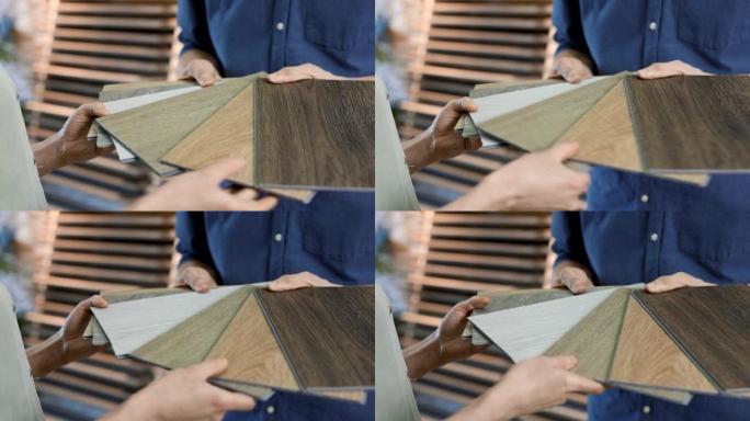 室内设计商店推销员向客户展示材料样品