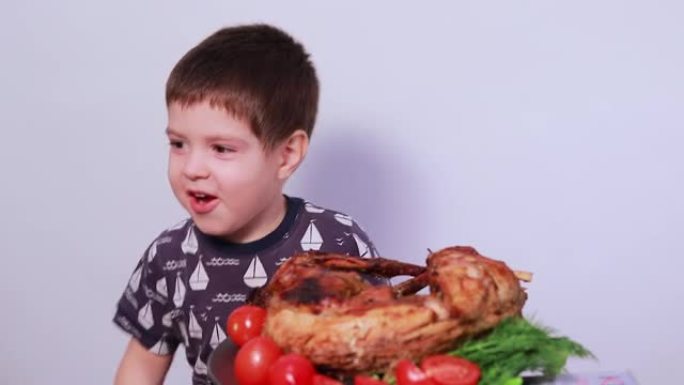 一个3-4岁的男孩吃兔肉。儿童、儿童和肉类的适当营养