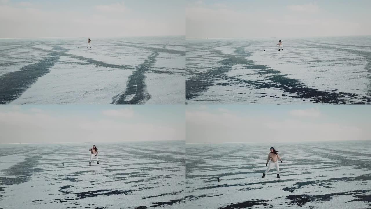 时尚的年轻女子，专业的舞者，在寒冷的冬天在北极冰冻的湖上跳舞充满活力的爵士放克或嘻哈。女性潮人在冰雪
