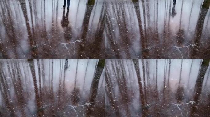 一个人在冰冻的森林湖中的倒影