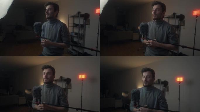 年轻的男性视频记录器准备在线视频内容并在家拍摄镜头前的谈话