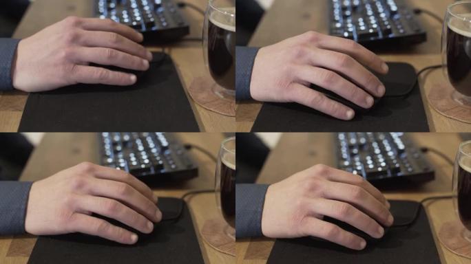 商人使用计算机鼠标并在工作时单击的特写镜头