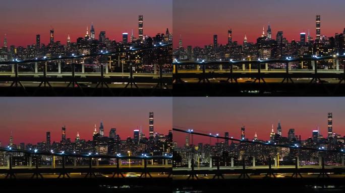 曼哈顿中城在夜晚照亮了天际线。RFK桥上有交通的景色。带有平移摄像机运动的无人机镜头。