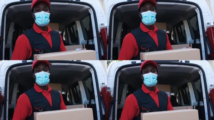 非洲男性快递员用卡车运送包裹，同时佩戴防护面罩以防止冠状病毒