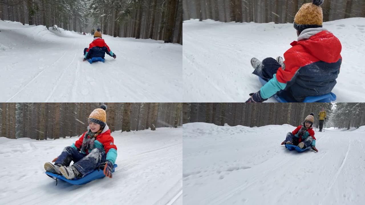 快乐的孩子，在塑料雪橇上下坡，超速行驶，幸福