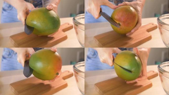 年轻女子用陶瓷刀在木砧板上切碎芒果。绿色冰沙排毒配方一步一步