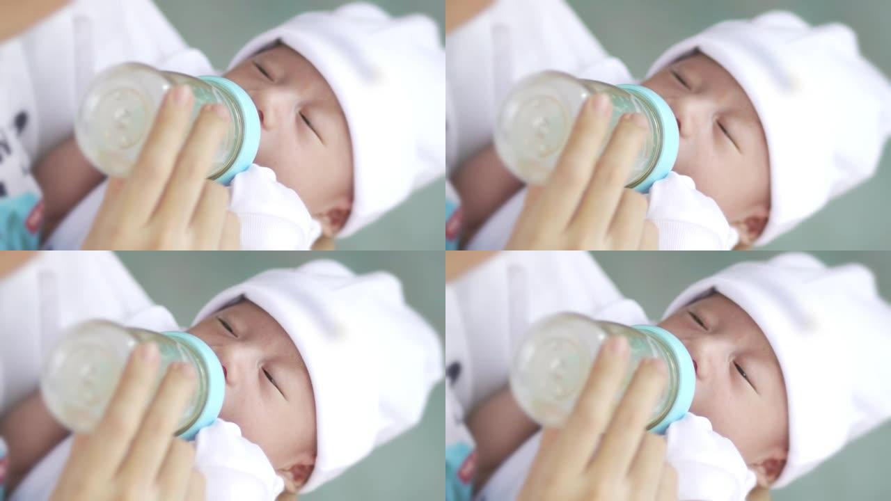 亚洲母亲用奶瓶喂养婴儿的慢动作