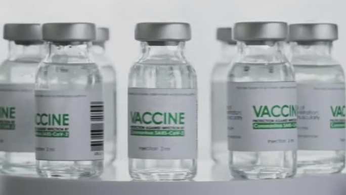 毛圈。研究实验室快速轮换使用新型冠状病毒感染的疫苗瓶。疫苗接种、注射、大流行期间的临床试验。烧瓶、小