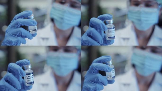 特写女医生手戴防护手套面罩戴手套注射器装疫苗冠状病毒治愈