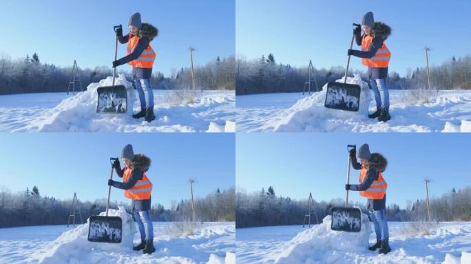 带雪铲的女看门人压碎了一堆雪