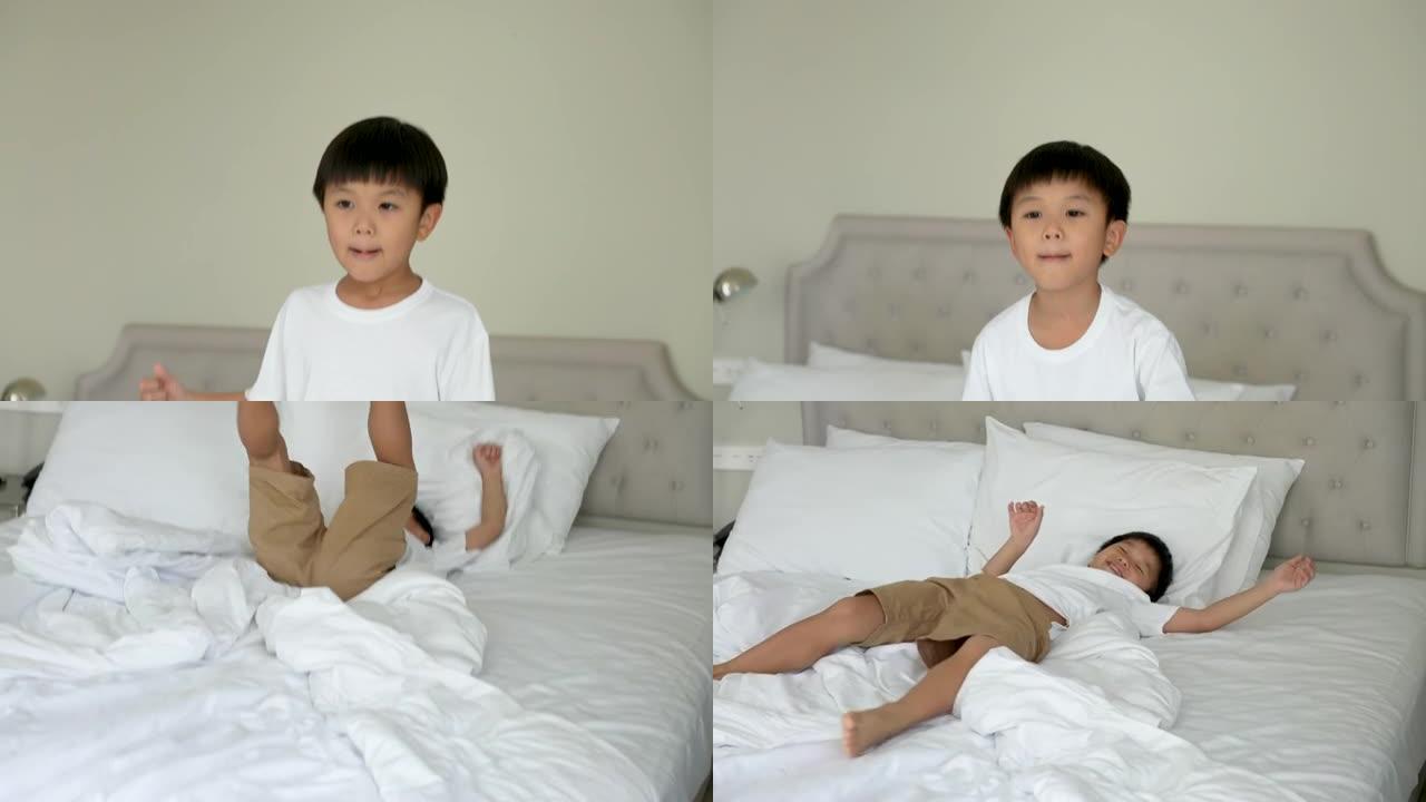 亚洲孩子跳上酒店的卧室。旅游和度假的概念