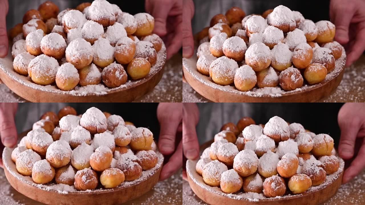 用糖粉烘烤的castagnole。街头美食，威尼斯狂欢节用糖做的圆形饼干。意大利狂欢节期间的传统甜糕