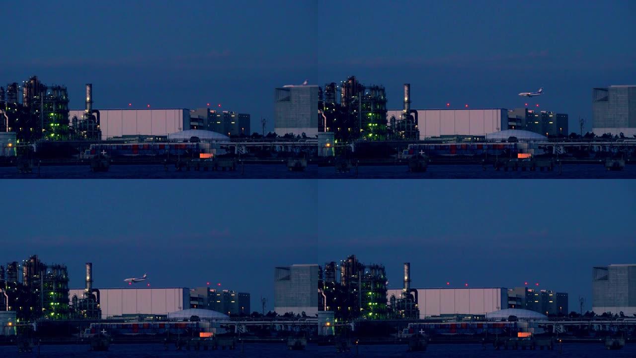 黄昏时炼油厂的景色。客机着陆。