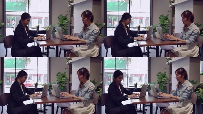 商务夫妇女人用笔记本电脑在咖啡馆工作。