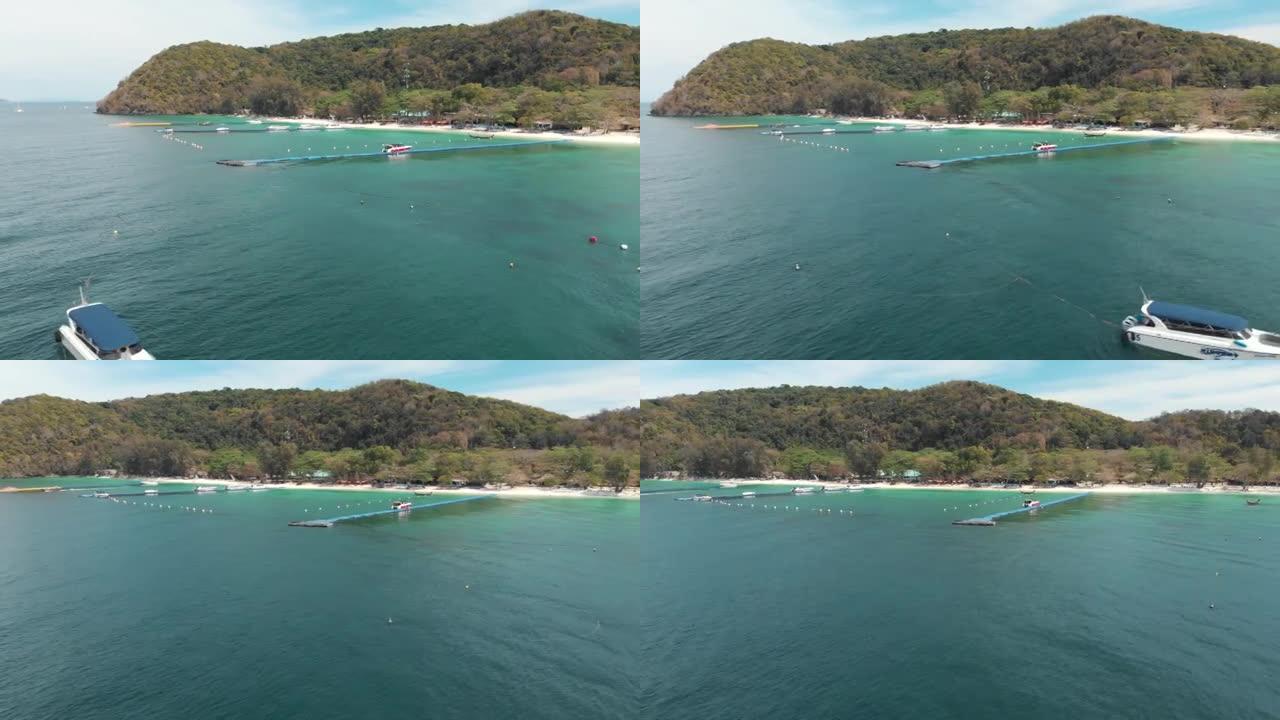 泰国Koh Hey (珊瑚岛) 的水晶般清澈的异国水域，带有浮动平台码头-空中低角度轨道调查拍摄