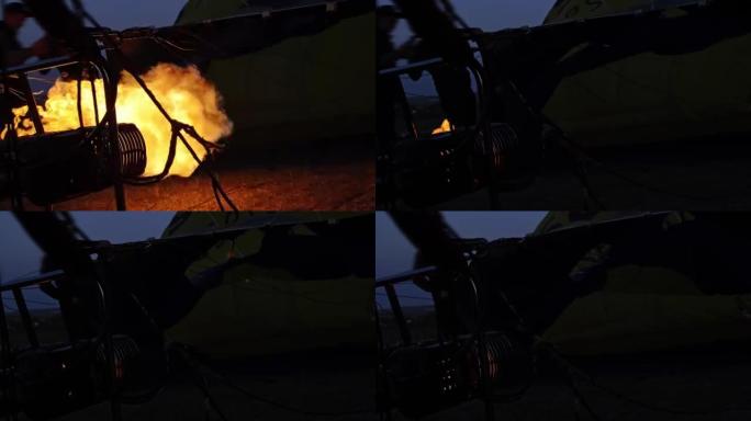 强烈的火焰在黎明时用特殊的燃烧器将热空气充满气球