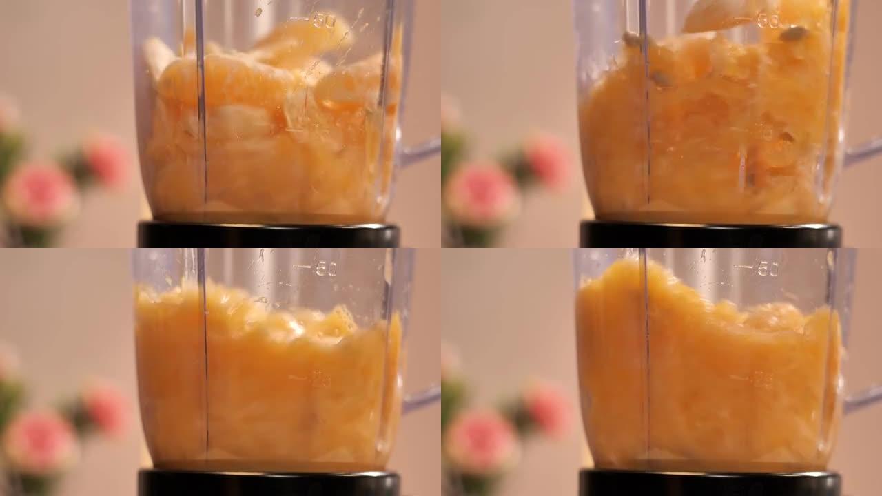 大量的橙片搅拌成透明的榨汁机搅拌机罐子-热带水果