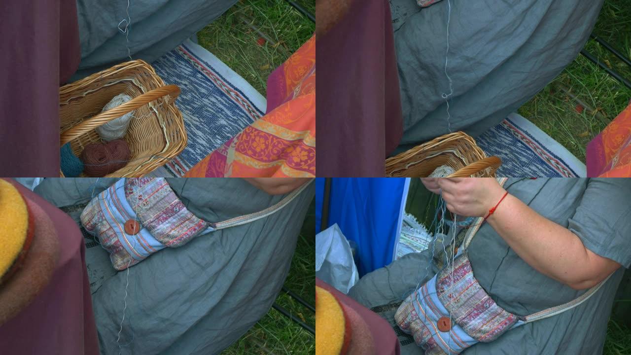 编织羊毛，在篮子里编织一个有经验的女人纱球