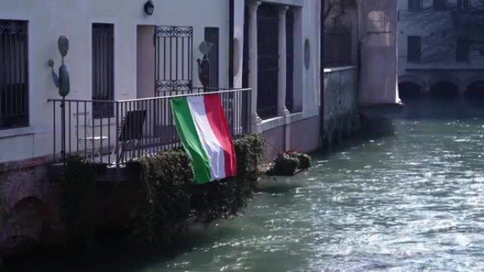 河上阳台扶手上的红色白色和绿色旗帜