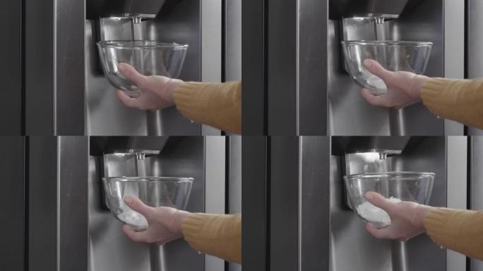 用冰箱制冰机的冰块装满碗，以准备茶点饮料。