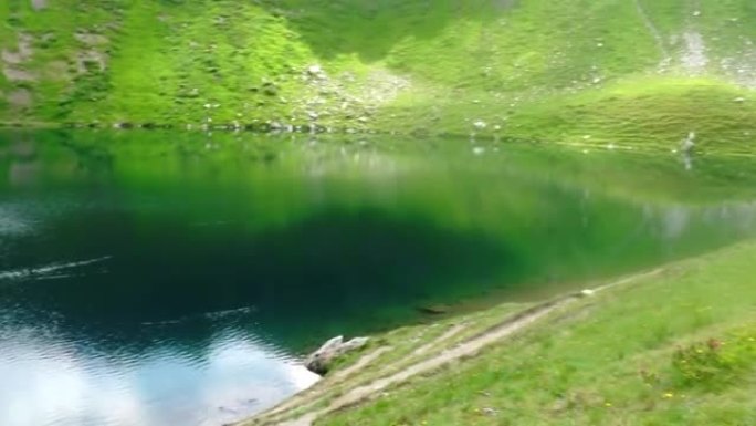 在奥地利徒步旅行时，绿山景观中的惊人山湖