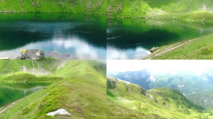 在奥地利徒步旅行时，绿山景观中的惊人山湖