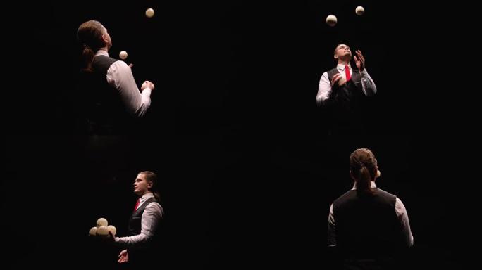 一个专业杂耍白球的时尚男人的轨道镜头。被灯光照亮的马戏团表演者在黑色工作室背景上投掷并接球。特写。慢