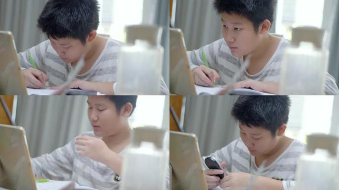 亚洲男孩使用数字平板电脑与老师和朋友在家里的餐桌上在线学习，这是新的正常生活方式概念。