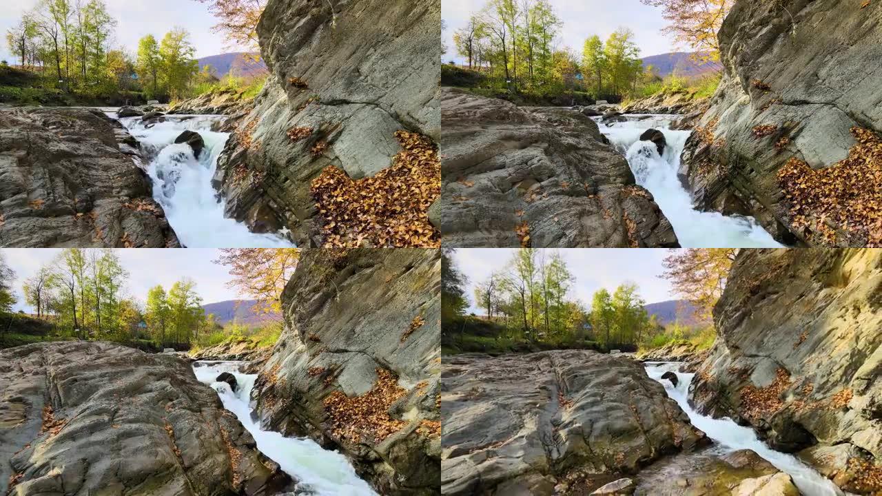 秋天在岩石石块之间快速流动的清水小山溪的鸟瞰图。