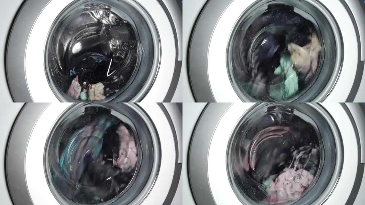通用家用洗衣机中的衣物洗涤。旋转洗衣机滚筒的特写视频。
