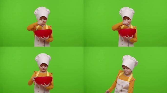 打扮成厨师面包师厨师的女孩小孩在碗中混合面团，在色度关键背景上准备蛋糕