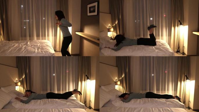 年轻女子晚上在酒店房间里上床睡觉