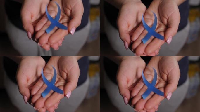 一个女人的特写镜头，她拿着一条关于糖尿病意识的蓝带。