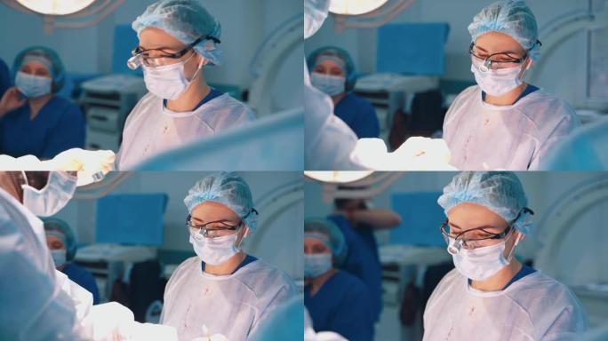 手术正在进行中。穿着医疗制服的专业外科医生进行整形手术。女助理帮助医生。