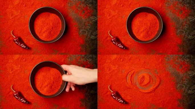 俯视图: 人类的手从桌子上拿了一个带有红辣椒粉的菜