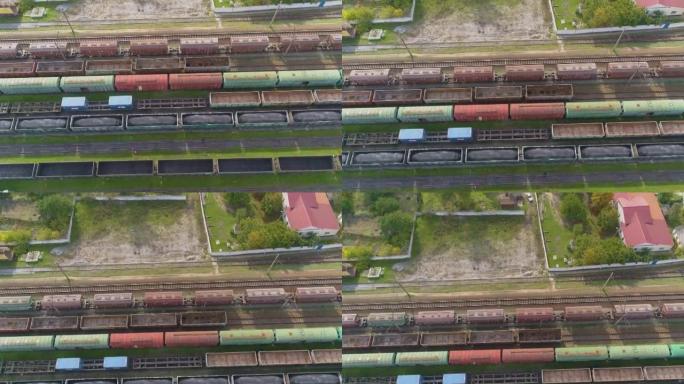 与货运列车的大型铁路交汇处俯视图。铁路枢纽货运列车的俯视图。在仓库的火车上飞行